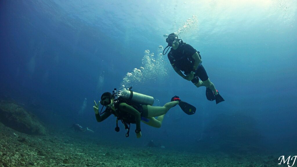 Scuba diver exploring crystal-clear waters during a training dive in Phuket