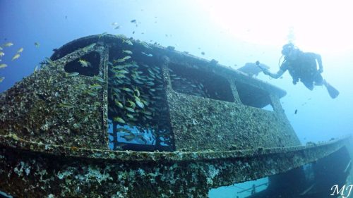 Artificial reef wreck at Racha Yai covered with fish.