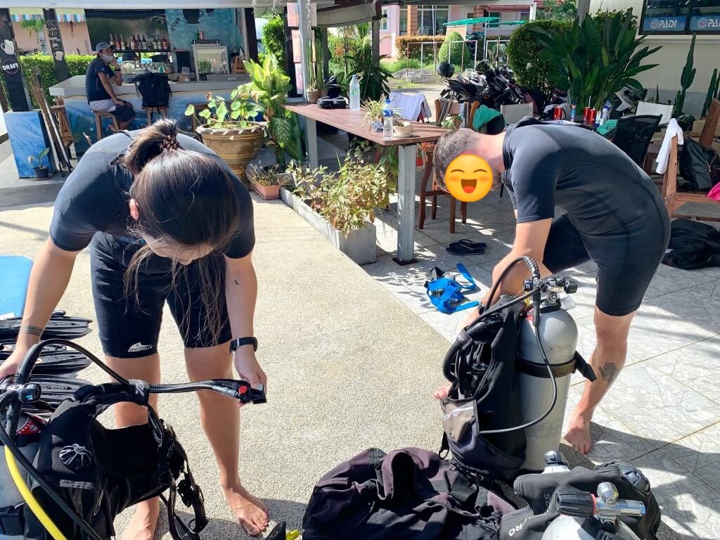 Student setting up scuba gear at the swimming pool before scuba review session