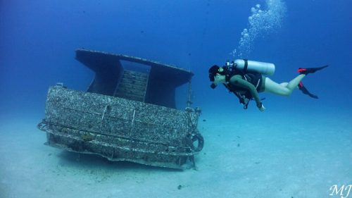 Racha Yai shipwreck dive site in Phuket with scuba diver.
